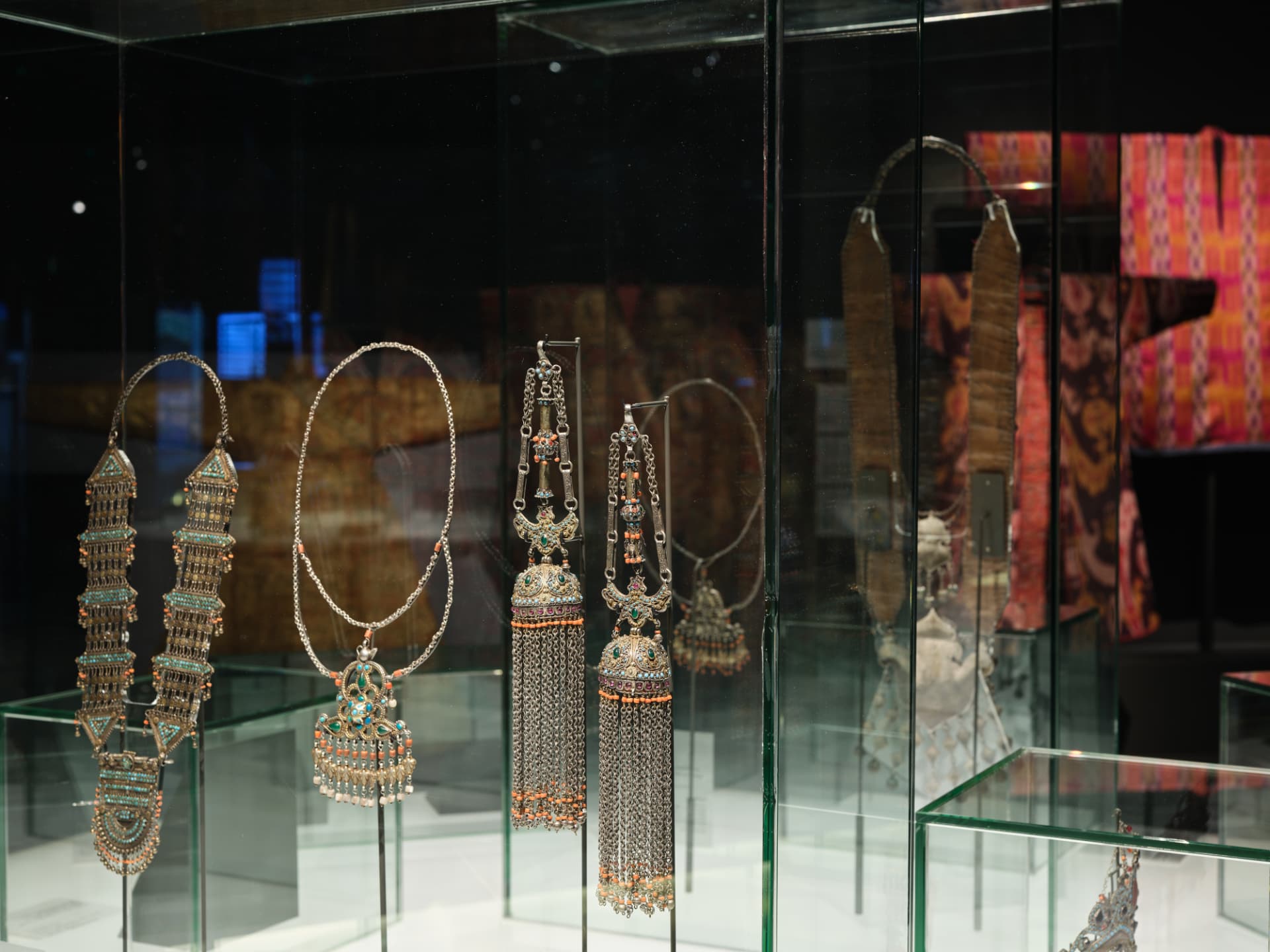 Uzbek jewellery and textiles displayed in lit glass cases